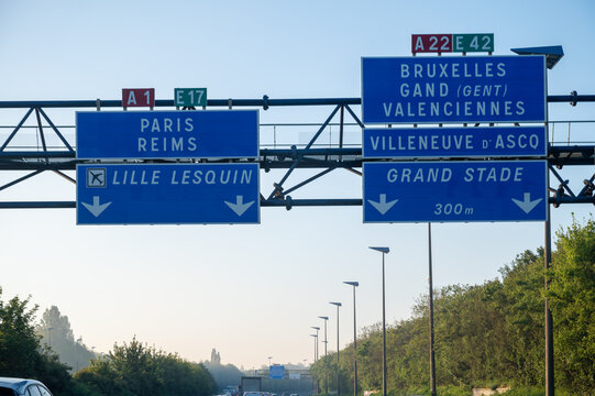 View of a French and European autoroute with overhead directional signs pointing to major cities like Paris, Bordeaux, Lille, Calais, showing lanes, traffic and motorway infrastructure, road signes
