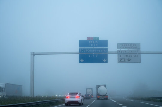 View of a French and European autoroute with overhead directional signs pointing to major cities like Paris, Bordeaux, Lille, Calais, showing lanes, traffic and motorway infrastructure, road signes