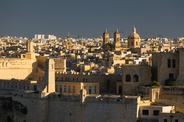 Fototapeta premium Charming historic streets and majestic architecture of Birgu (Vittoriosa), Malta. Admire the warm limestone facades, medieval defensive walls, and stunning waterfront marina views.