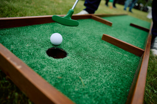 Mini Golf Putter and Ball on Artificial Green Putting Course