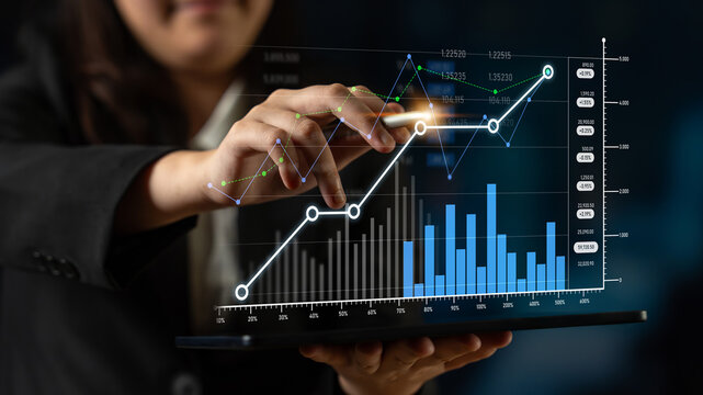 A business professional demonstrates financial growth using digital tools on a laptop, highlighting the importance of data analytics in modern decision-making processes. Scalp
