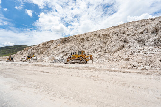 Cat 950GC loader, Cat SY365H Pro excavator and Cat truck expanding Manzanillo Guadalajara highway. dump truck moving rocks on a mine road. Manzanillo, Colima, Mexico, July 20, 2026.
