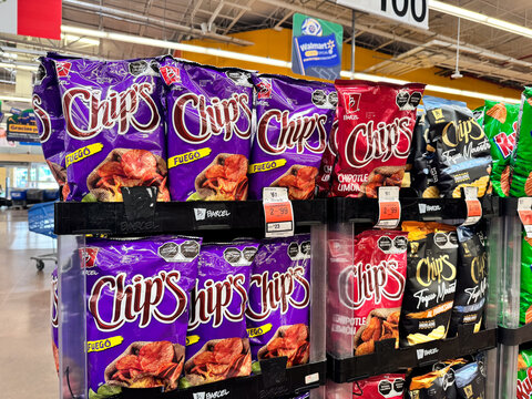 Bags of Chip's Flamin Hot potato chips by Barcel, Grupo Bimbo displayed on a supermarket shelf. Spicy savory snacks on retail store racks. Jalisco, Mexico July 11 2026.