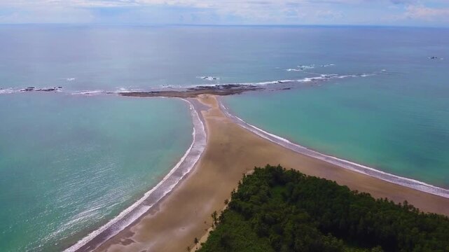 Drone flyover of Whale Tail Beach, Marino, Ballena National Park, Uvita, Costa Rica