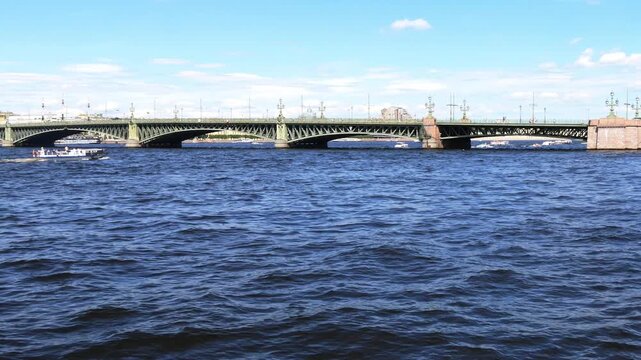 SAINT PETERSBURG, Russia- June 29, 2026: Troitsky Bridge over the Neva River. Sightseeing boats with tourists sail along the river. A hot sunny summer day.