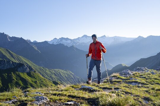 Hiker enjoying the mountain panorama in the morning, Venediger group, behind Dreiherrenkopf, Simonysitze and Gro&szlig;er Geiger, Hohen Tauern, Austria