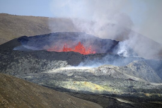 Sulphur fields in front of volcanic craters, glowing lava fountains, steam and shimmering air Fagradal Falls, Reykjanes, Grindavik, Iceland