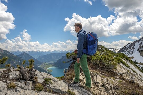 Hiker on hiking trail, crossing from the Seekarspitz to the Seebergspitz, view over the Achensee, Tyrol, Austria