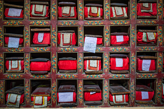 Wooden shelf with ancient Tibetan Buddhist scriptures in Ladakh