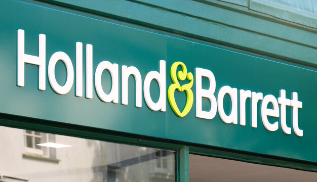 Holland & Barrett logo. Sign outside British-based multinational health and wellness retailer with global presence. Known for supplement range, diet products and natural remedies. 