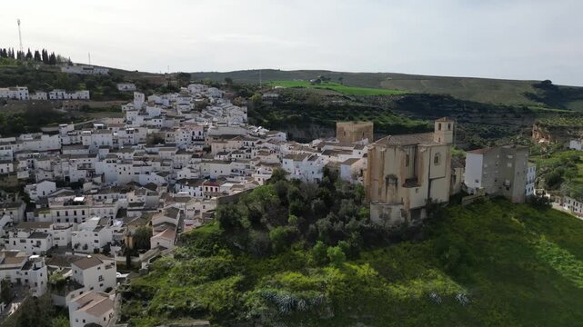 Sideways Aerial Pan Showcasing Setenil de las Bodegas Castle Before Revealing Cave Town and Village Behind, Andalusia, Spain