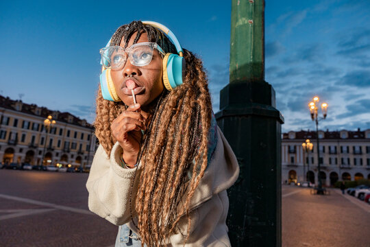 Gen Z woman enjoying urban lifestyle with headphones