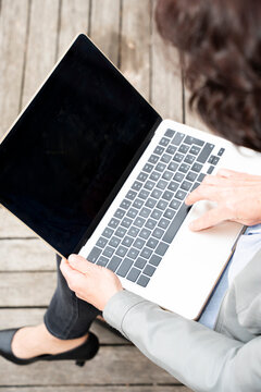 Woman using laptop in outdoor setting