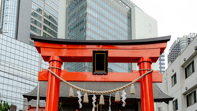 Torii amidst modern skyscrapers in Tokyo's Minato district