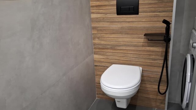 Toilet in a modern bathroom with wood wall. interior, restroom, home, hygiene, shower.