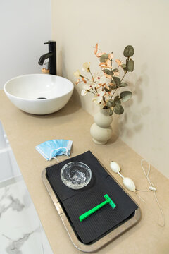 Beauty clinic hygiene setup with razor and disinfectant tray