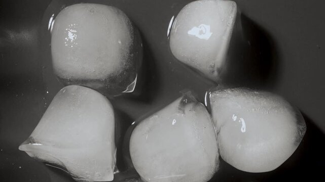 Timelapse macro of melting ice cubes turning into water