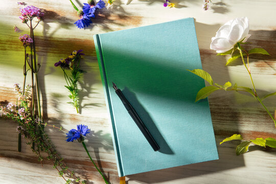 Mindful outdoor journaling with flowers and notebook