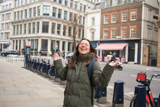 Cheerful woman enjoying solo trip in London streets