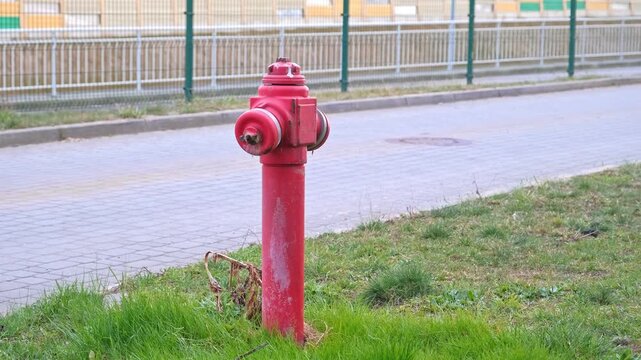 Water Dripping from Leaking Red Street Hydrant due to Damaged Seal