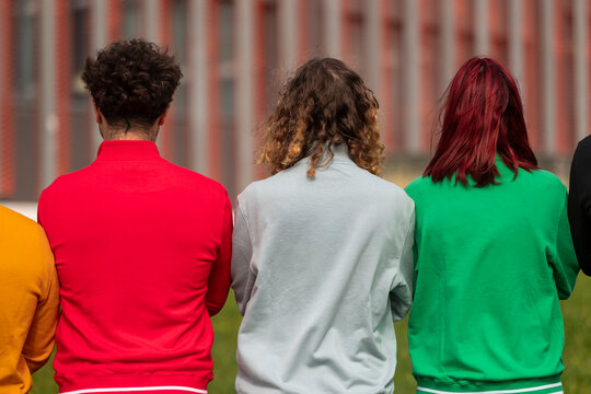 Diverse colorful sweatshirts from behind
