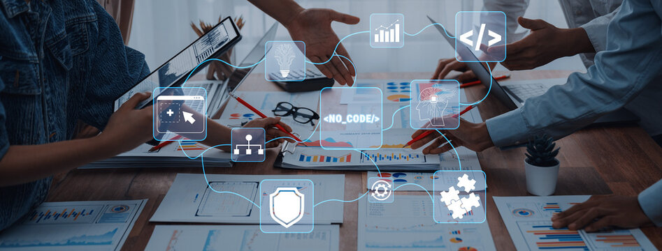Hands of diverse professionals collaborating on business strategies with data charts and digital icons symbolizing technology and innovation in the workplace Quark.