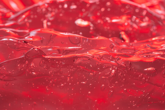 Macro view of glistening red gel texture
