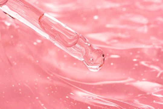 Macro view of pipette with pink gel texture