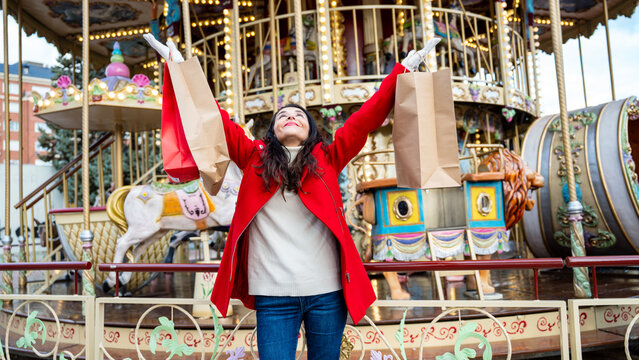 Joyful woman with shopping bag at Christmas market ride