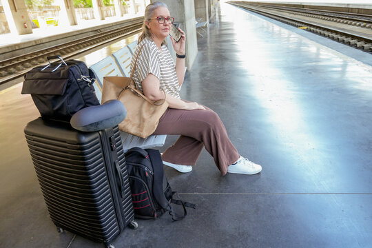 Waiting for the train with anticipation and luggage