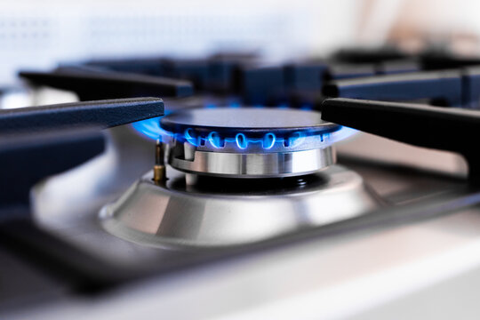 Close-up of blue gas flame on modern kitchen stove