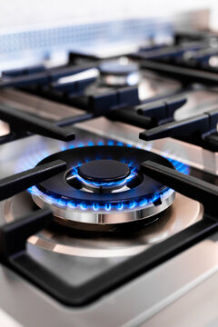 Close-up of blue flame on modern gas stove burner