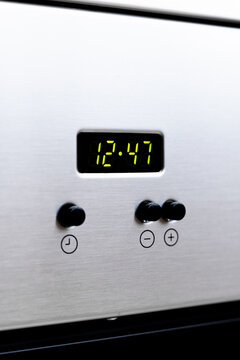 Stainless steel oven clock display with control buttons