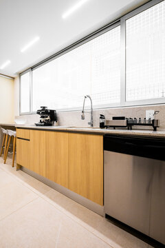 Modern kitchen counter with sink, dishwasher and coffee maker