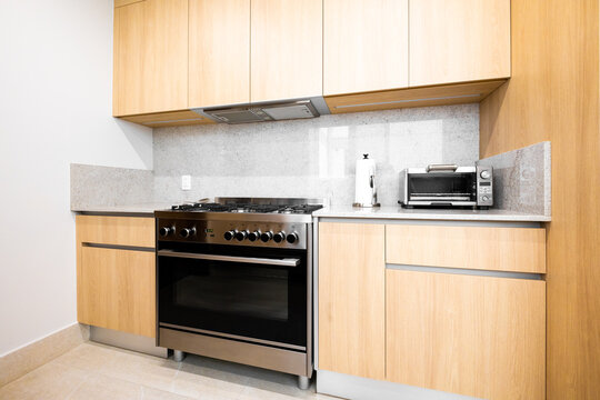 Modern kitchen corner with wooden cabinets and stove