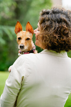 Woman and dog share a moment in the park