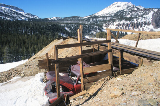 Abandoned truck and mine in mountains.