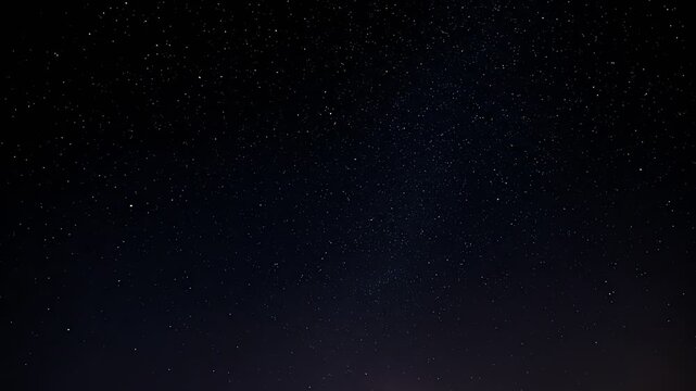 A dark blue, star-filled night sky fades into a lighter, brighter horizon