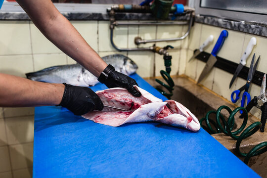 Fishmonger preparing fresh fish in Lisbon market