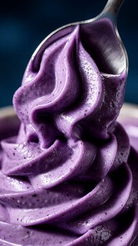 Purple soft serve ice cream being lifted by spoon closeup