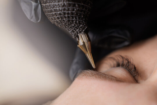 closeup of eyebrow tattooing procedure on caucasian female with hightlight