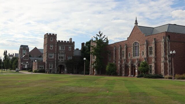 Red brick university buildings with green lawn.