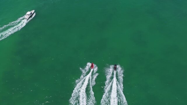 Vacation on summertime. Aerial view at vacation. Jet ski in motion. Summer vacation activity. Water sport activity in summer. Sea beach lifestyle. Beach life concept