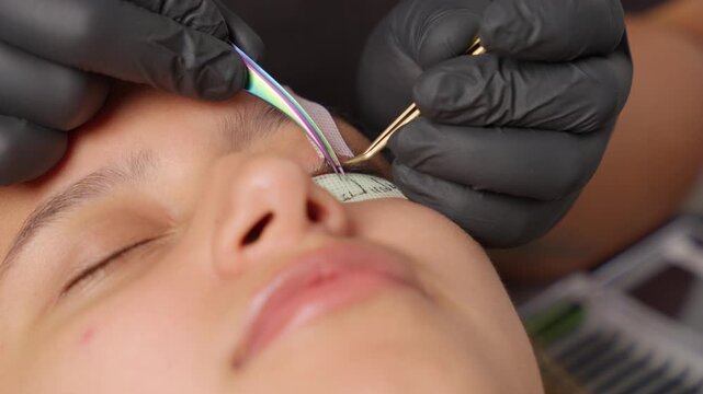Beautician applying eyelash extensions in a beauty salon