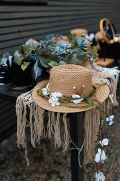 Straw hats decorated with flowers and macrame elements in boho style.