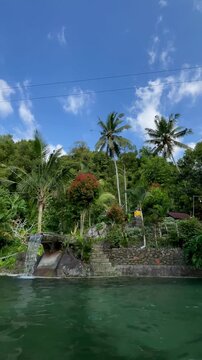 Vertical Static Shot of Emerald Eco Pool and Tropical Waterfall in Bali

