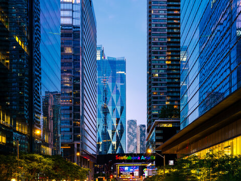 Toronto, ON, Canada - Jun 27, 2025: Twilight view of Scotiabank Arena and skyscrapers around it located in downtown Toronto, ON