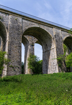 Historic Chirk viaduct and aqueduct stand tall above a picturesque meadow in the scenic Ceiriog Valley, Shropshire, UK.