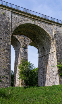 Historic Chirk viaduct and aqueduct stand tall above a picturesque meadow in the scenic Ceiriog Valley, Shropshire, UK.