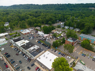 Fototapeta premium Aerial view showing suburban town with retail stores